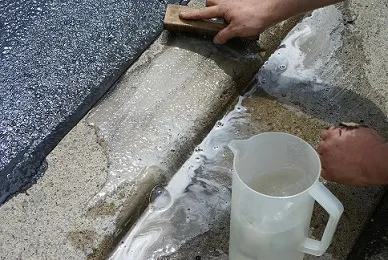 cleaning asphalt sealant leak on driveway